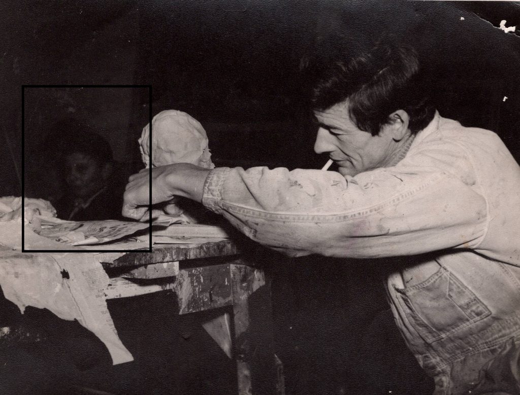Black and white photo of Jim Wigley making a puppet head
